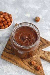 chocolate-spread-nougat-cream-with-hazelnuts-glass-jar-concrete-copyspace_200x300